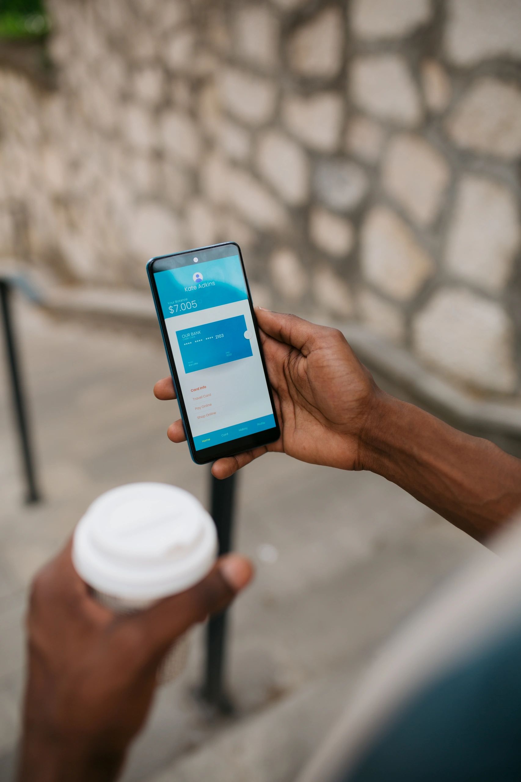 Person using a smartphone while out for coffee