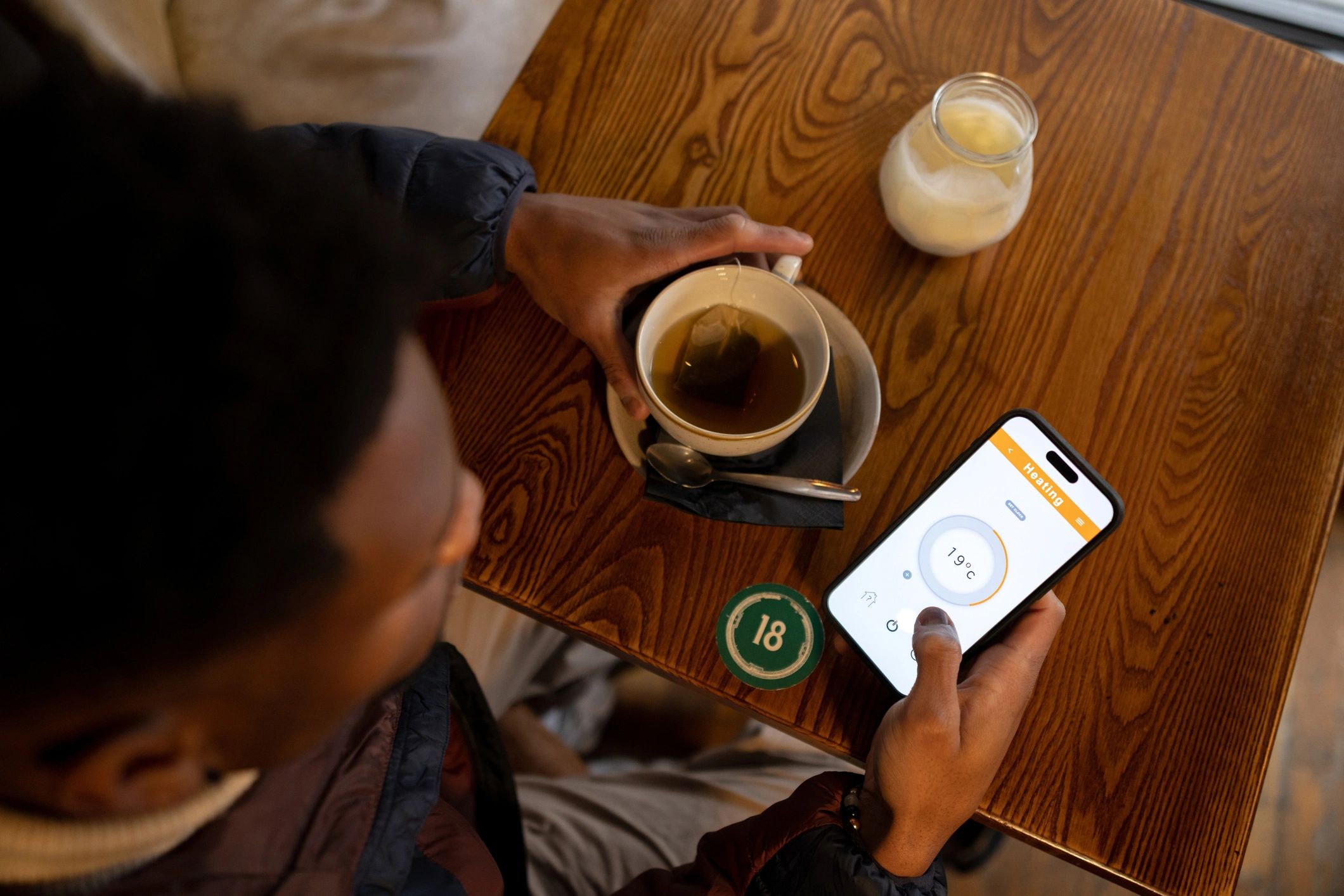 Person using a smartphone in a cafe
